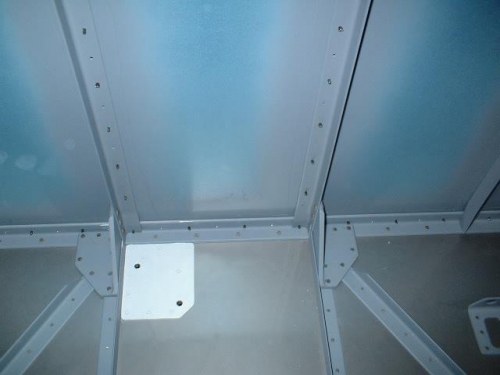 Center two floor stiffeners riveted to firewall brackets