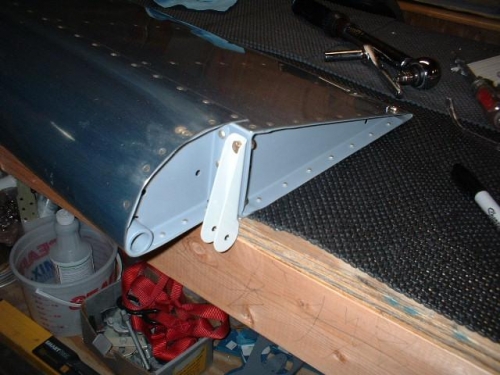 Outboard bracket bolted to left aileron