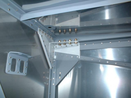 Firewall brackets bolted to lower longerons