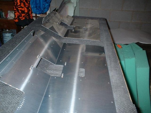 Nutplates riveted to forward seat floors for stick boots