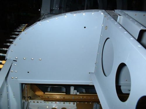 Right sub panel riveted to bulkhead, deck, and center section