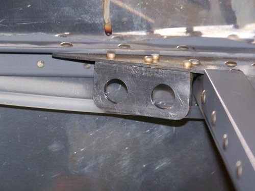 Bracket for pilot headsets riveted to fuselage