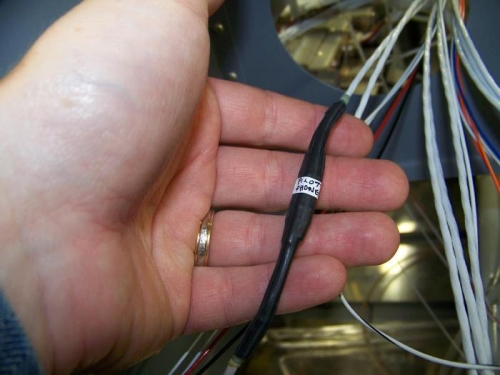 Pilot headphone cable with heat shrink over the entire connection