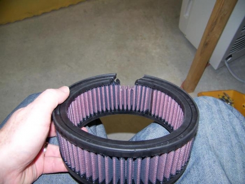 Trim air filter to fit over accelerator pump