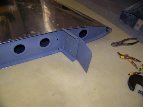 F-781 plate and F-781B spacer riveted to front spar of vertical stabilizer