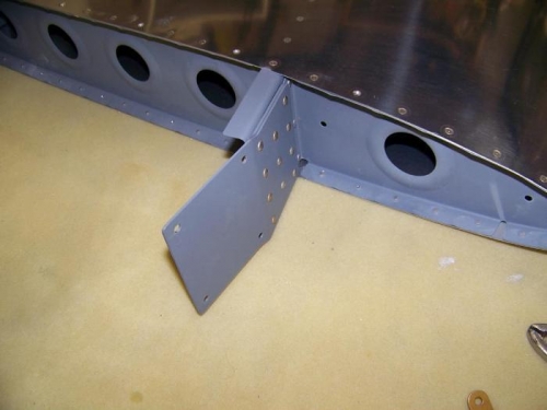 F-781 plate and F-781B spacer riveted to front spar of vertical stabilize