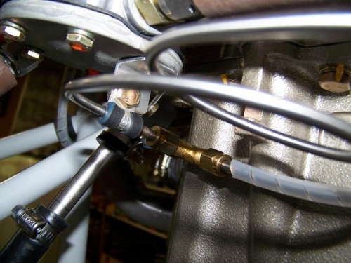 Primer line from the gascolator with service loop connected to brass T fitting at back of engine
