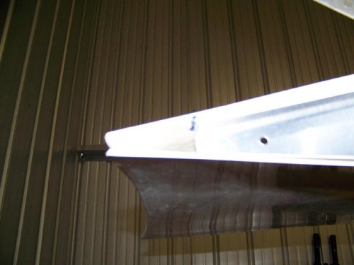 Aft edge of left wing tip rib marked on fiberglass - top flange