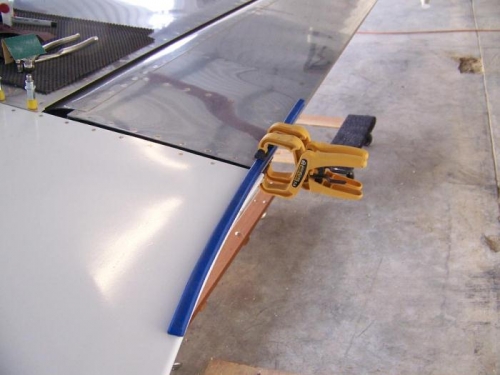 Flexible drafting tool clamped in place to mark contour for trailing edge