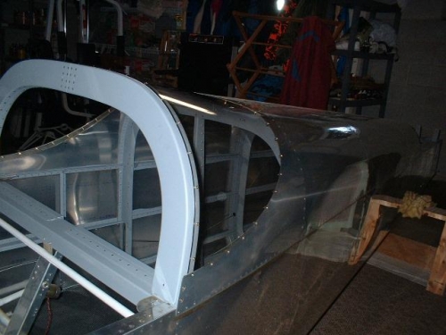 Rear window permanently installed and fastened to fuselage