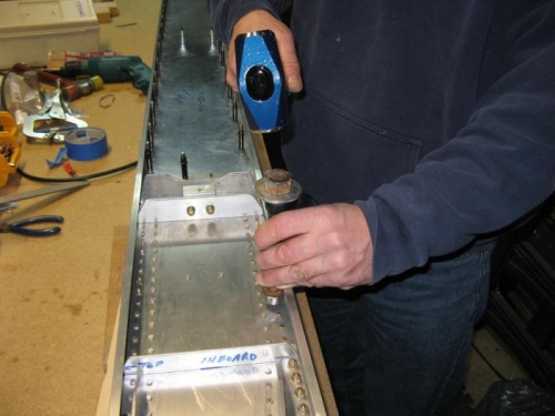 Hand riveting next to spar cap