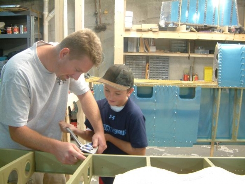 Ben teaching his son the fine art of squeezing rivets