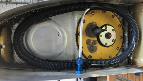 Fuel vent hand-coiled and encased in sheathing.