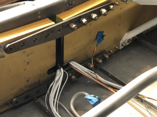 Installed the main spar cutout bushings to protect the wire bundles.