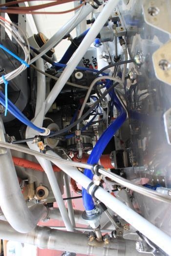 The silicone hose works upward to the separator on the firewall.