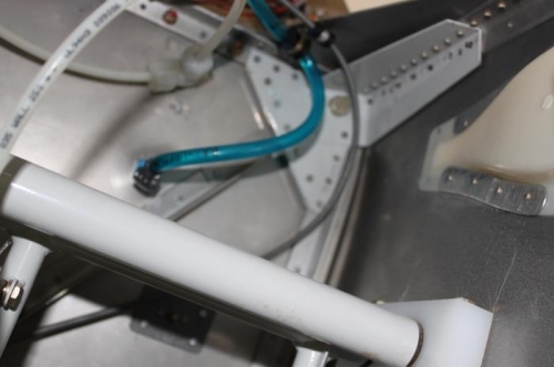 Looking up in top right corner where cable is secured before turning down at firewall.