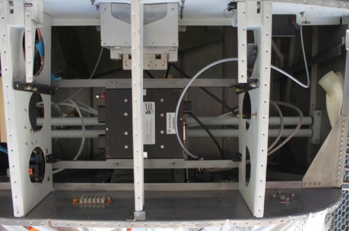 Cable is on right coming under the sub panel curving up and center before down in front. 3 clamps.