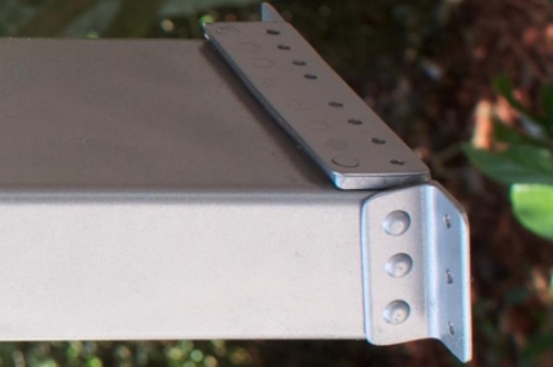 The 032 spacer on top of the angle lowers the rollbar brace, letting window fit under topskin.