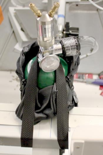 Upper attach loops around the O2 tank neck and then down under the fuselage cross member on each side.