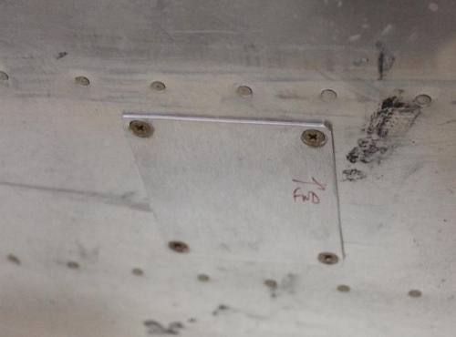 Doubler goes underneath on top of bottom skin. Gear leg fairing will cover this on the -6A