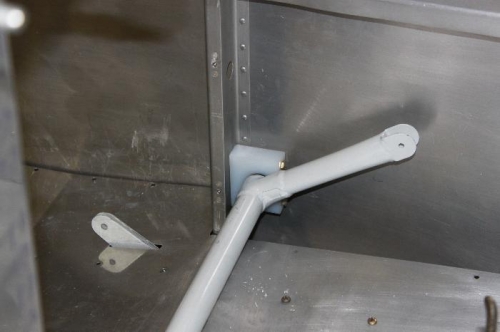 Copilot side .369 inches clearance between baggage floor and bottom of flap weldment.