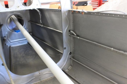 From aft fuselage along J stringer, through bulkhead.