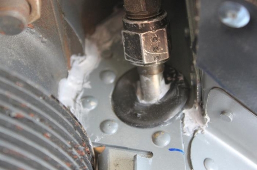 Forward 1/3 of rubber oil line grommet has a deeper cut in it to fit the off center hole. RTV'd too.