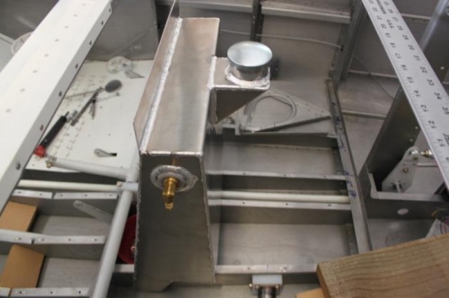 The tank upper flange fits between the F605 crossmember and canopy latch mechanism. I posed it for pix