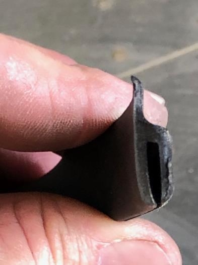 That bump out slot slips under the wing fairing and resulting pressure forms the curved seal