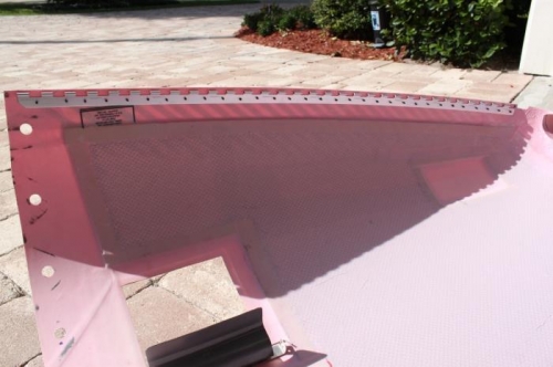 Top cowl hinge drilled in place, fiberglass countersank, ready for glue and rivets.