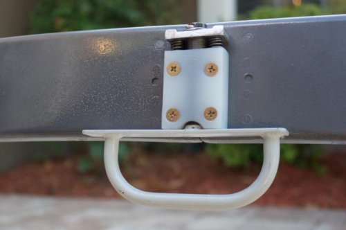 Mounted so the open position is immediately above the bend of the canopy bow flange.