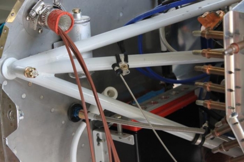 End of wire line at engine mount tube. Connected wires will then go through firewall opening.