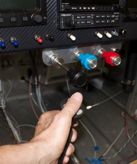 Throttle at full closed. Simulates free control movement before engine start. Thumb is clear.