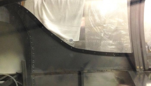 Pilot side backing strip along inside edge. Black paint and 3 sections overlapping.