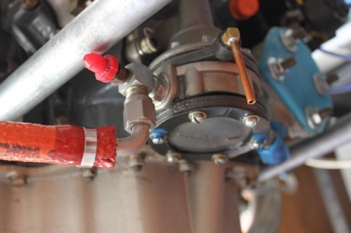 Fuel pressure line goes where red cap is. Drain line clamps on copper fitting.