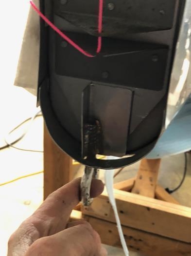 Trimmed cutout for installation of rear tiedown bracket