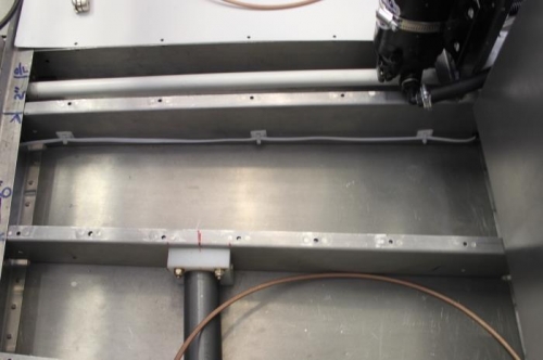 ELT wire enters next bay and is secured with riveted/adhesive zip tie mounts.