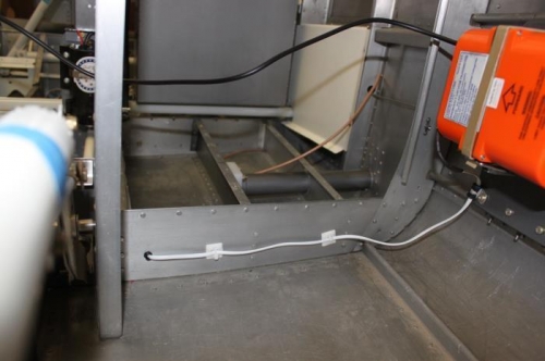 ELT wire enters behind baggage wall bulkhead and is secured over to ELT.