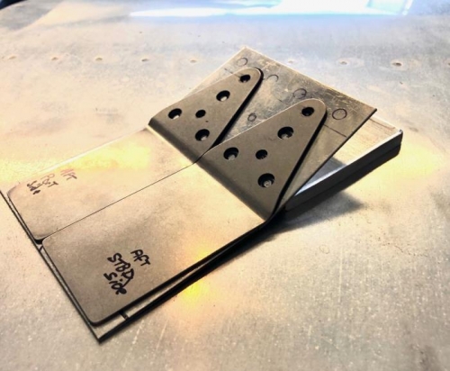 Reinforcement has large holes that allow for AD4 rivets to nest inside of.  Small holes for new bolts.