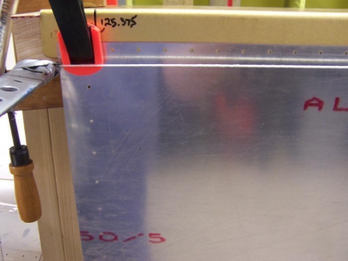 stretch a line end to end tight at bottom of spar flange.