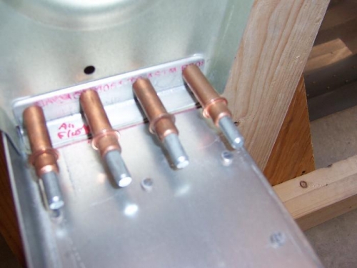 Angle cut, trimmed, drilled, and clecoed to rib web.