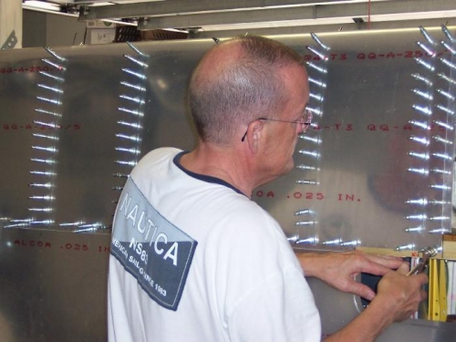 Putting in the Last Clecoe in the Last Hole on Leading edge skin.