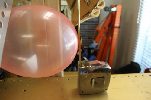 Placed the tape measure at the end of the balloon