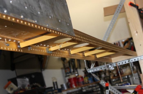 Spacer underneath tie down attachment