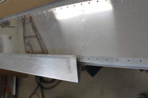 Slide the bottom skin into the fold of the upper skin and cleco the overlap