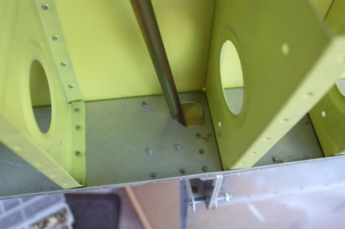 Cut access hole for aileron bellcrank connecting rod.