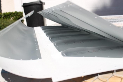 Skin trailing edge bent, all drilled, dimpled, primed