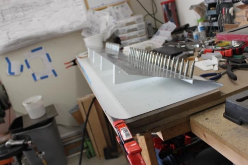 Leave the top side unclecoed while you set the overlapping skins.  Easier to position bucking bar.