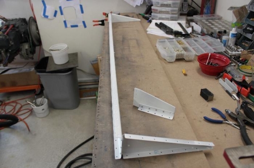 Rivet end ribs to flap spar