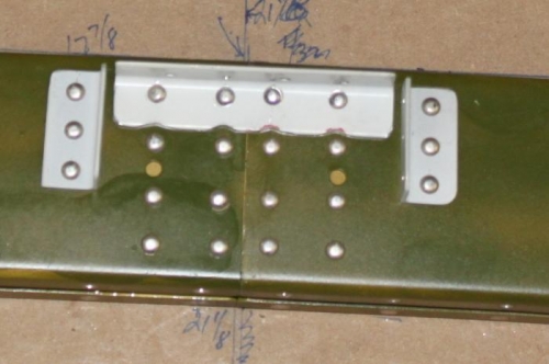 Connector plate, angles, and roll bar are final riveted.